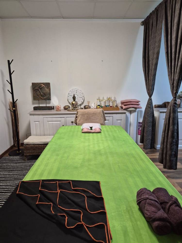 Massage bed prepared with a green sheet